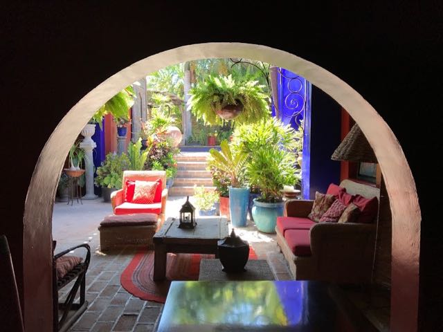 View of outdoor seating area in red and blue at Hotel California in Todos Santos