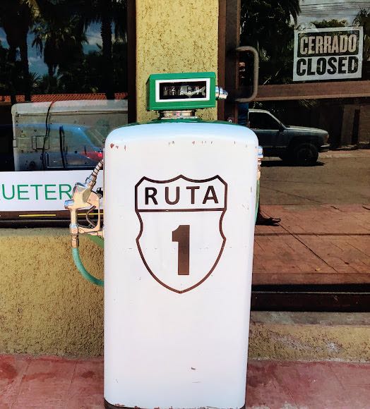 Old gas pump with Ruta 1 highway sign on it